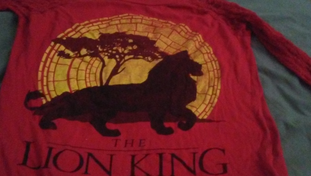 This is a red ladies size Medium Lion King shirt.